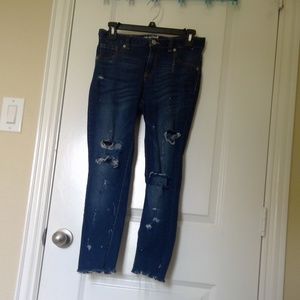 ripped blue skinny jeans with distressed hem